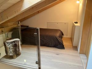 a small room with a bed in a attic at Klosters/Davos - topfloor luxury apartment with extraordinary views in Klosters Dorf