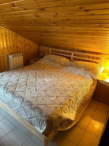 a bedroom with a bed in a wooden room at Sangro Chalet By Dimorra in Castel di Sangro