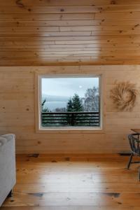 Habitación con ventana en una cabaña de madera en Rangeley Lake House, lake access, Saddleback 15min, en Rangeley