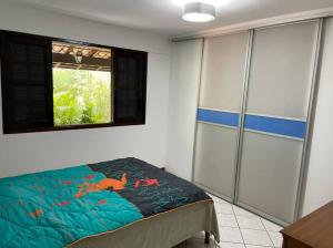 a bedroom with a bed and a window in it at Casa Barlavento com Piscina e Praia em Angra - RJ in Angra dos Reis
