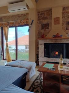 a room with two beds and a fireplace at studio Nick in Kalavrita