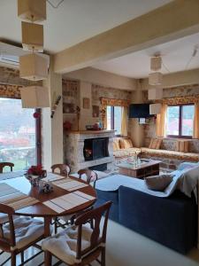 a living room with a blue couch and a table at studio Nick in Kalavrita