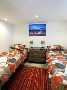 two beds sitting next to each other in a room at Cocali Cottage - Stunning, Spacious property close to Deal Beach ! in Walmer