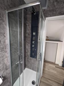 a shower with a glass door in a bathroom at Cocali Cottage - Stunning, Spacious property close to Deal Beach ! in Walmer