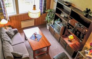 ein Wohnzimmer mit einem Sofa, einem Tisch und einem TV in der Unterkunft Cozy Apartment In Agdenes With House A Mountain View in Selva