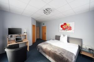 Postel nebo postele na pokoji v ubytování Komm' In Hotel