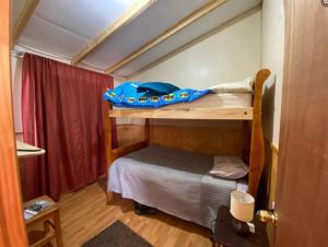 a small room with a bunk bed in a room at Cabañas Rukapillán Región de la Araucanía in Villarrica