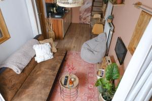 an overhead view of a living room with a couch at Tiny House Hilver - uniek en sfeervol huisje middenin het bos in Diessen