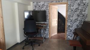 a room with a desk with a television and a chair at Apartment /flat in Schwebheim