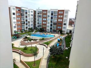 an overhead view of a swimming pool in a apartment complex at Suites Apart Piura in Piura