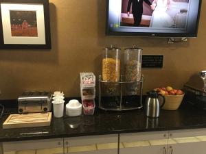 a kitchen counter with a blender and a tv at Wingate by Wyndham New Stanton in New Stanton