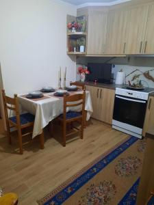 a kitchen with a table with chairs and a stove at Christo's Place Katarraktis Artas in Katarráktis +15 photos