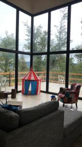 a living room with a tent in front of a large window at Zorro Azul - Corazón de la Isla - Tierra del Fuego in Tolhuin