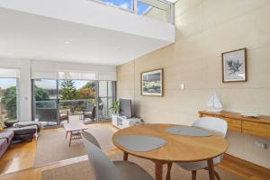 a living room with a table and chairs at Alouarn Apartments in Augusta