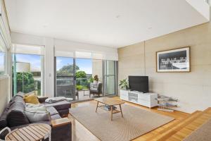 a living room with a couch and a tv at Alouarn Apartments in Augusta