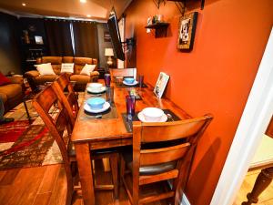 a dining room with a wooden table and chairs at Perfect DTWN 2 Bed Condo with Cali King Bed and Gym in Atlanta