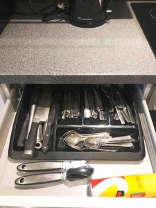 a tray of utensils sitting on top of a stove at Light-luxury Flat in Glasgow