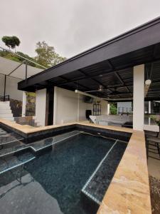 a swimming pool in the backyard of a house at Casa Proa in Uvita