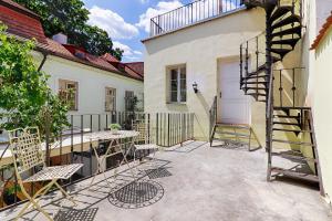 a patio with a table and chairs next to a building at Smyrna Boutique Apartments in Prague