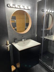 a bathroom with a sink and a mirror at Home Vars. Le studio in Vars