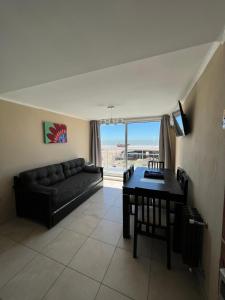 a living room with a couch and a table at Ocean Blue in San Clemente del Tuyú