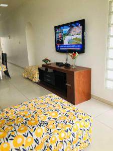 a living room with a tv and a bed at Casa con piscina-Wifi alta velocidad in Lima