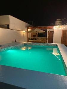 a swimming pool in a house at night at Casa con piscina-Wifi alta velocidad in Lima