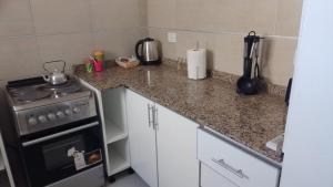 a kitchen with a stove and a counter top at PLAZA376 2 in Chivilcoy