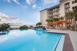 a large swimming pool in front of a hotel at Holiday Inn Club Vacations Galveston Beach Resort, an IHG Hotel in Galveston