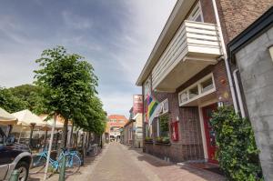 a cobblestone street in a small town with buildings at Hotel Oepkes in West-Terschelling