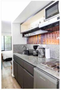 a kitchen with a sink and a counter top at Confortable apartamento con la perfecta ubicación! in Bogotá