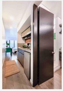 a kitchen with a stainless steel refrigerator in a room at Confortable apartamento con la perfecta ubicación! in Bogotá