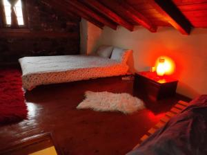a bedroom with a bed and a light on the floor at Cozy Mountain Villa in P. Agios Athanasios in Palaios Agios Athanasios