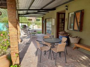 a patio with a table and chairs on it at Sueño Bonito in San Andrés de Giles