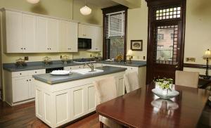 a kitchen with a sink and a table with a dining room at Morgan State House Inn in Albany