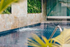 a swimming pool with a fountain in front of a building at Exclusive Anglesea River Beach Apartment in Anglesea