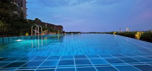 a large swimming pool with blue tiles on it at Oasisstay 4 Bedrooms Apartment With Studio at Bangi Sentral in Bandar Baru Bangi