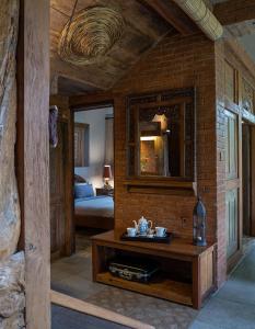 a living room with a table and a brick wall at Nienté Bali in Penebel