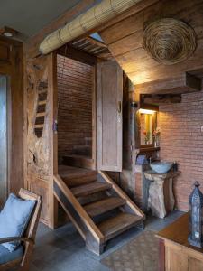 a room with a wooden staircase in a house at Nienté Bali in Penebel