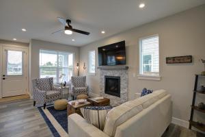 a living room with a couch and a fireplace at Gone Coastal Oyhut Bay Seaside Village in Ocean Shores