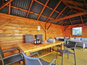 a wooden room with a wooden table and chairs at Apartment with a terrace, very close to the beach, Ustronie Morskie in Ustronie Morskie