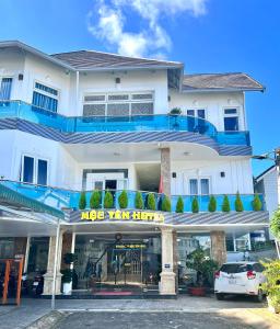 a large white building with a sign on it at Mộc Yên Hotel in Da Lat