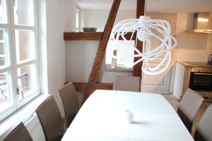 a dining room with a white table and chairs at A L'ill - Apparts & Studios Strasbourg Hyper Centre in Strasbourg