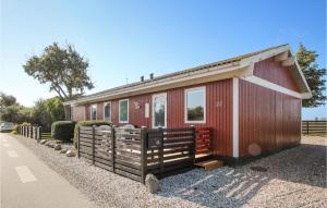 a red tiny house with a fence in front of it at Pet Friendly Home In Sams With Kitchen in Ballen
