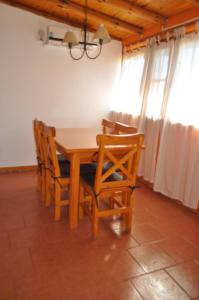 a dining room with a wooden table and chairs at la martina in Villa Giardino +5 photos