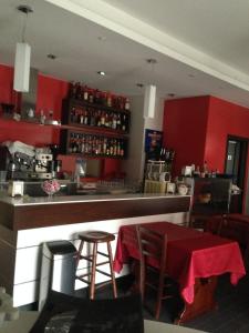 a kitchen with red walls and a counter with a table at B&B 21-12 in Saviano