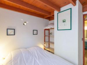 a bedroom with a bed with a picture of a dog on the wall at Chalet Cauterets, 4 pièces, 6 personnes - FR-1-401-254 in Cauterets