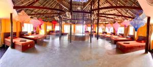 a room with rows of tables in a building at M'pay Bay Guesthouse in Koh Rong Sanloem