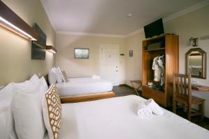 Una cama o camas en una habitación de Gran Hotel Bahia