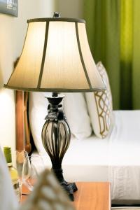 a lamp sitting on a table next to a bed at Gran Hotel Bahia in Bocas Town +45 photos